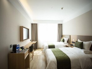 A hotel room with two beds, a desk, and a chair. - Greentree Inn Ankang Middle Bashan Road Business Hotel (Ankang)