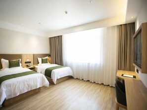 A hotel room with two beds, a desk, a chair, and a large window with curtains. - Greentree Inn Ankang Middle Bashan Road Business Hotel (Ankang)