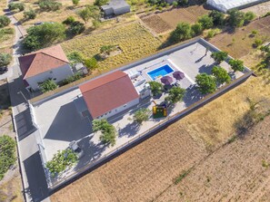 An aerial view of a residential property with a swimming pool, patio area, and a fenced garden. - Villa Antonia is near Trogir with a private pool (Marina)