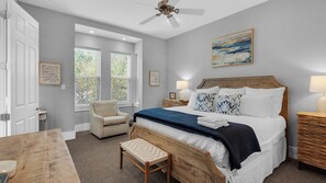 A bedroom with a bed, bedside tables, a chair, a bench, and a ceiling fan. - Private Pool, Easy Walk to Beach, 5 Bikes + Free Dolphin Cruise! (Santa Rosa Beach)