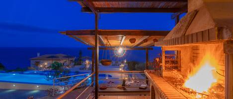 A balcony with a view of a swimming pool and a building in the background.