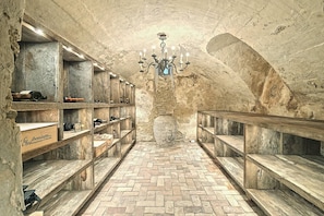 Experience the timeless charm of this historic space with a vaulted ceiling, chandelier, and traditional herringbone tiles.