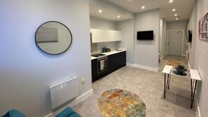 A modern apartment with a kitchen, dining area, and living space. - Kempston Suites Liverpool Apartment 2 (Liverpool)