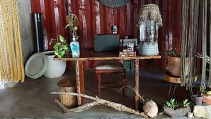 A rustic interior with a wooden table, a clock, and various decorative items. - Uman Glamping & Cenote Tulum (Tulum)