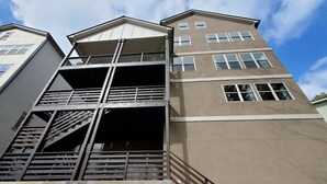A multi-story building with a central staircase and a balcony.