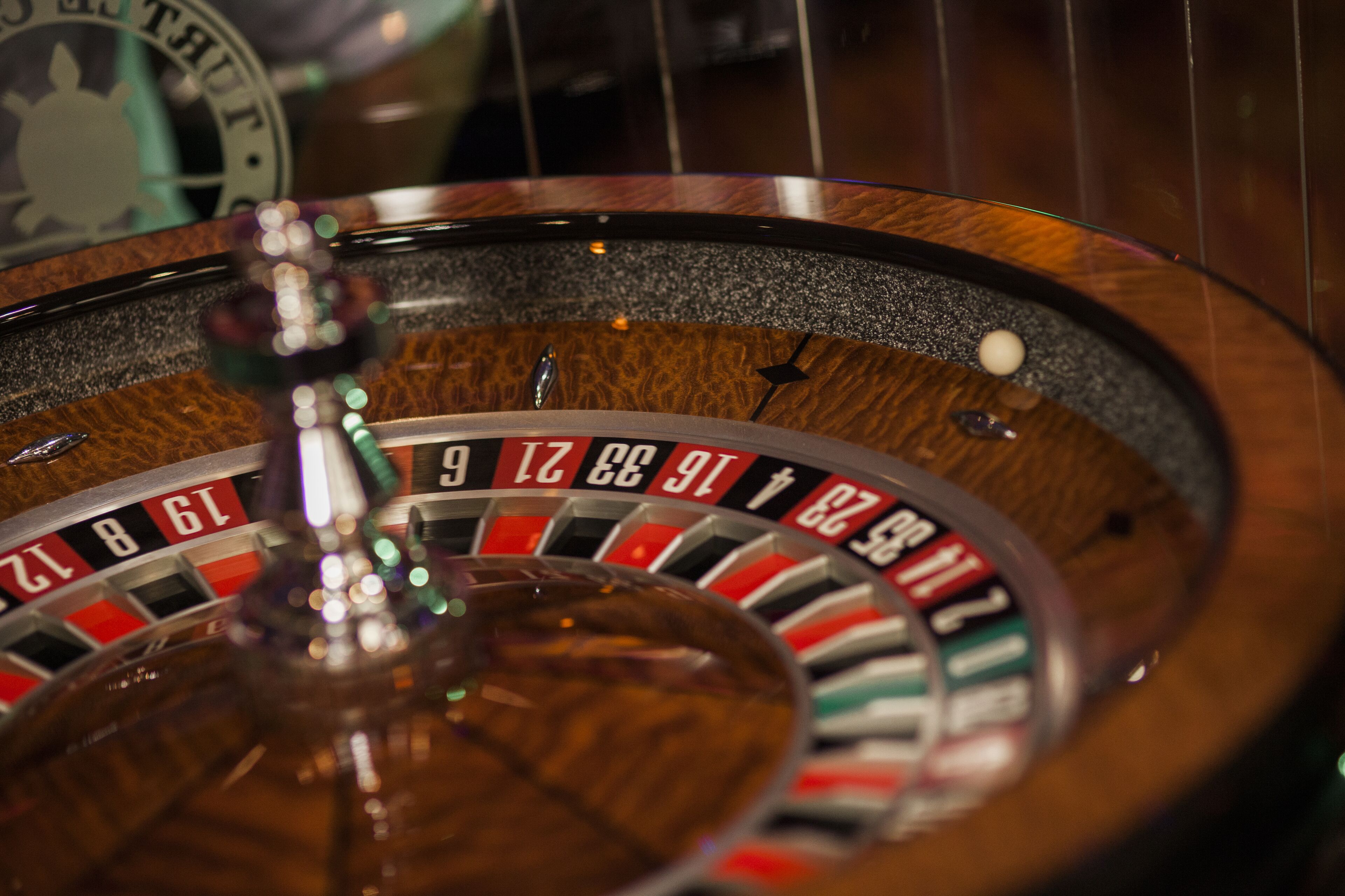 A roulette wheel with numbers and a ball.