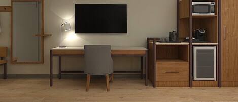 A compact room with a desk, chair, and built-in microwave shelf.