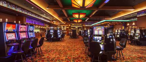 A casino with multiple slot machines, a cashier area, and a 'Birch Room' sign.