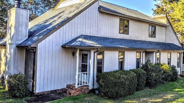 A two-story house with a gabled roof, a front porch, and a chimney. - Spacious  Home with Incredible Location (Charlotte)