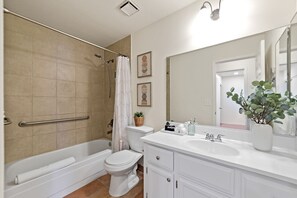 Banheira, secador de cabelo, toalhas de banho 