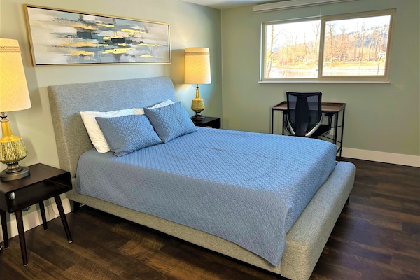 Master Bedroom, queen bed, writing desk and river view.