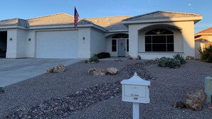 A residential building with a garage, a front entrance, and a mailbox. - Beautiful, cozy home minutes from Laughlin and the river!! (Bullhead City)