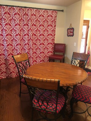 Enjoy meals in this cozy dining area with a round table and four comfortable chairs.