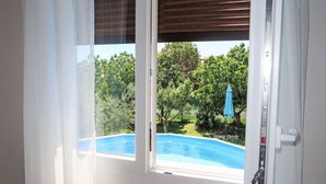 A room with a view of a swimming pool and greenery outside. - Vacation home Laura by Interhome (Pićan)