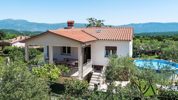 A two-story house with a red-tiled roof, a balcony, and a swimming pool. - Vacation home Laura by Interhome (Pićan)