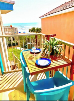 Enjoy al fresco dining with a view of the ocean and a building in the distance.