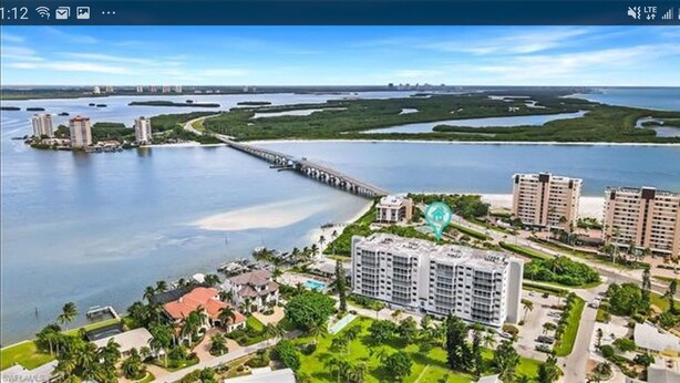 An aerial view of a coastal area with a bridge, residential buildings, and a marina. - Large Fort Myers Beach 2 Bedroom Condo (Fort Myers Beach)
