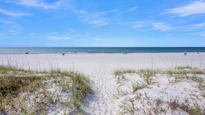 A beach with sand dunes and a clear blue sky. - Beachfront Duplex | Shared Heated Pool | Pet Friendly (Gulf Shores)