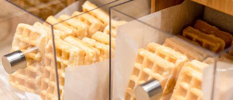 A waffle display with clear plastic containers holding waffles.