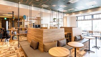 A modern interior with wooden furniture, a reception desk, and a large window.