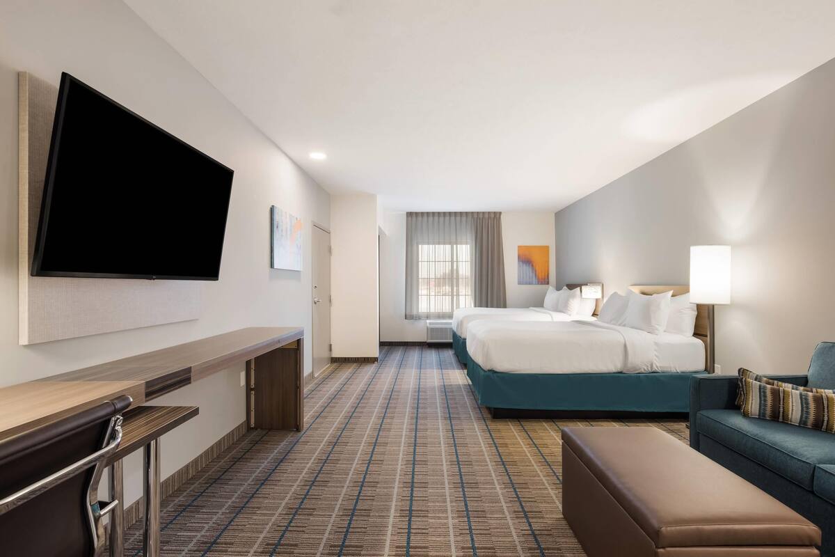 desk, laptop workspace, iron/ironing board, bed sheets