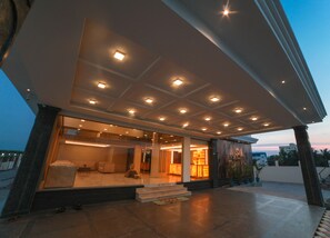 A modern hotel entrance with a covered outdoor area, large windows, and a well-lit interior. - Ramrathna Residency (Madurai)