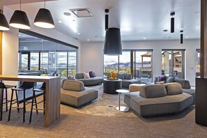 A modern living area with sofas, a coffee table, and a bar area.
