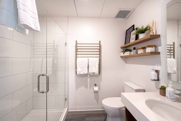 The private bathroom is well appointed with quartz counters, heated towel rack and an over sized walk in shower.