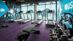 A gym with treadmills, weight benches, and dumbbells. - Tru by Hilton Ha Long Hon Gai Centre (Hong Gai)