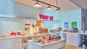 A breakfast buffet area with various food stations, including yogurt, cereal, and a coffee station. - Tru by Hilton Ha Long Hon Gai Centre (Hong Gai)