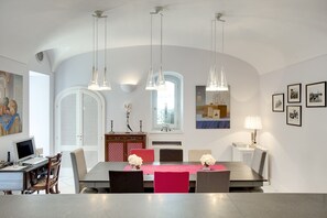 Enjoy meals with friends and family at this spacious dining area, featuring a long table and comfortable seating for six.