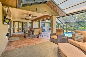 A spacious patio with a dining area, outdoor seating, and a view of a swimming pool. - Port Charlotte Retreat w/ Heated Pool & Spa! (Port Charlotte)