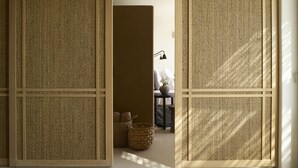 A room with a traditional Japanese shoji screen door, a small table with a lamp, and a wicker basket. - Collini Hotel Mykonos, WorldHotels Elite (Mykonos)