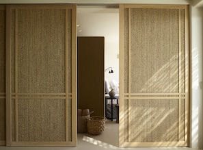 A room with a traditional Japanese shoji screen door, a small table with a lamp, and a wicker basket. - Collini Hotel Mykonos, WorldHotels Elite (Mykonos)