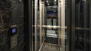 An elevator interior with a marble wall, a digital display, and a control panel with buttons. - The Trinity Hotel Taksim - Special Class (Istanbul)