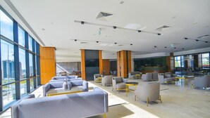 A spacious lobby with modern seating, large windows, and a high ceiling. - Serenity Comfort Hotel  (Istanbul)