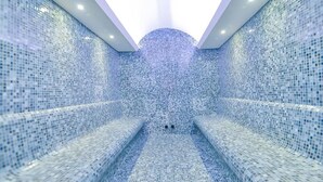 A modern spa with mosaic-tiled walls and benches. - Serenity Comfort Hotel  (Istanbul)