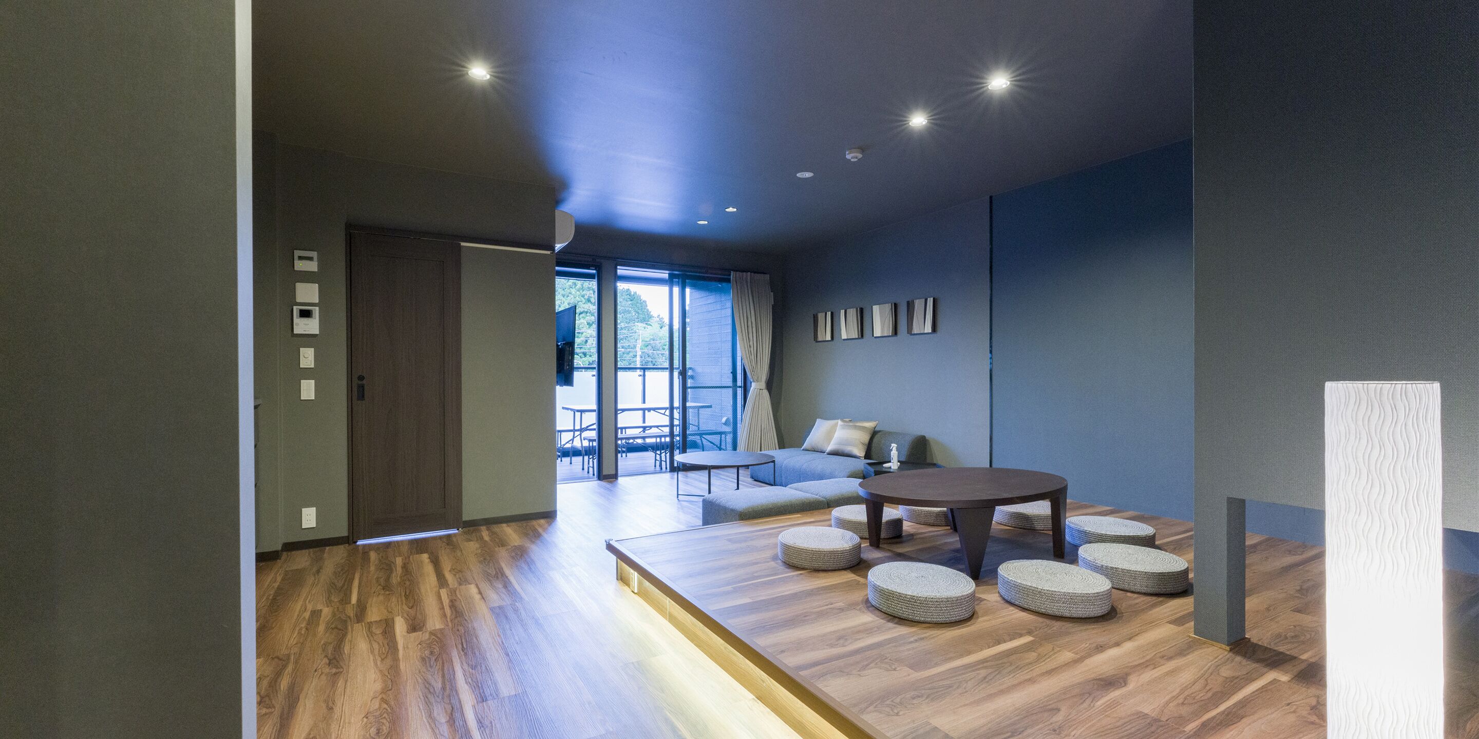 A modern living room with a wooden floor, a round coffee table, and a sofa.