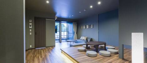 A modern living room with a wooden floor, a round coffee table, and a sofa.