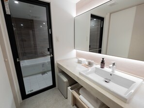 A modern bathroom with a large mirror, white sink, and a glass shower enclosure. - Hotel THE LEBEN OSAKA (Osaka)
