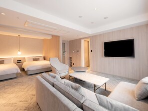 A modern hotel room with a large bed, a sofa, a coffee table, and a flat-screen TV mounted on the wall. - Hotel THE LEBEN OSAKA (Osaka)