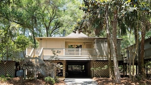 A two-story house with a covered porch and a garage entrance.