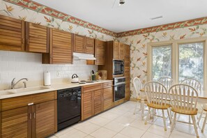 Enjoy cooking in the well-equipped kitchen with appliances and dining area.