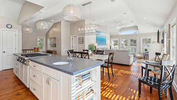 A spacious kitchen with a large island, white cabinetry, and pendant lighting. - Heatable Pool, Short Walk to Beach, Luxury Living! Sweet Carolina (Folly Beach)