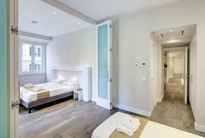 Deluxe Quadruple Room | Down duvets, in-room safe, desk, laptop workspace