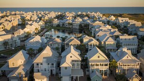 A coastal residential area with houses featuring gabled roofs and a central water body. - Cozy Beach Home in Cinnamon Shore w/ Easy Access to Resort Amenities (Port Aransas)