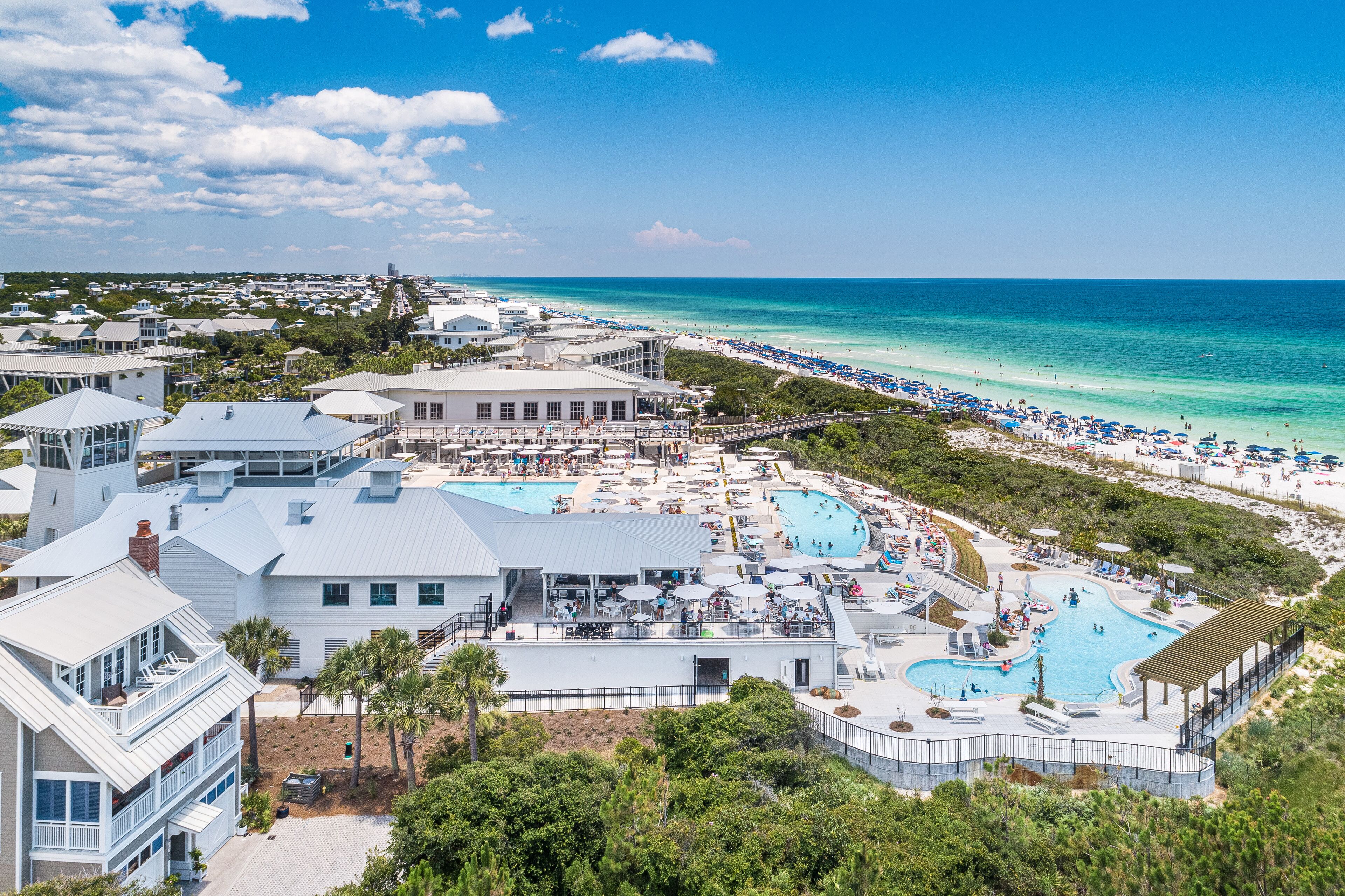 A resort with multiple swimming pools, beach access, and a view of the ocean.