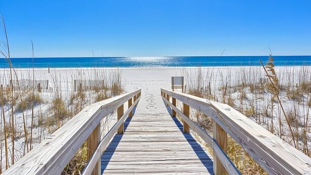 A wooden boardwalk leading to a beach with clear skies. - The best location in Orange Beach - Ground floor condo - NEW to rental market (Orange Beach)