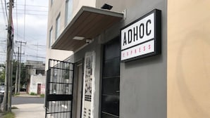 A building with a sign reading "ADHOC EXPRESS" on the side. - Adhoc Cintermex (Monterrey)