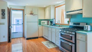 A compact kitchen with a refrigerator, microwave, stove, and oven. - Book Eastham, Plenty Of Room For Entire Family! (Eastham)
